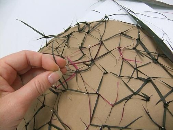 Keep adding pins to keep the strands in position. Keep adding pins to keep the strands in position.