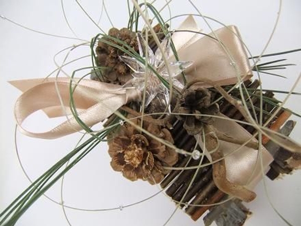 Pine needles, pine cones and ripped flax to decorate the twig gift box