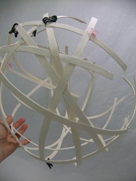 Continue to weave the cane strips in a ball shape Continue to weave the cane strips in a ball shape