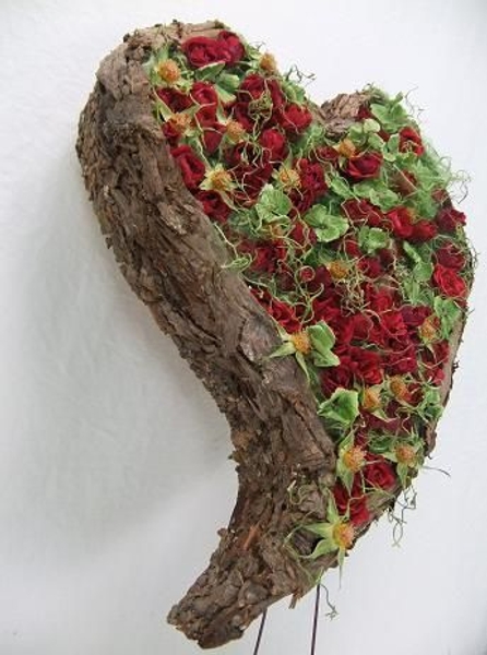 Cover cardboard with bark to create a heart shaped armature. Cover cardboard with bark to create a heart shaped armature.