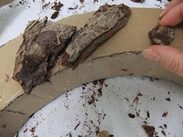 Cover the arch shape with chips of bark