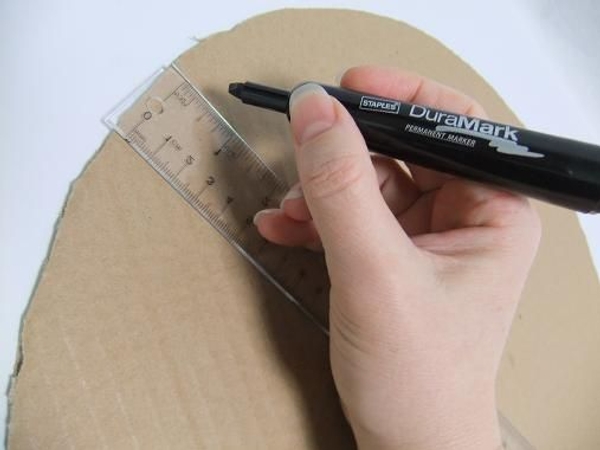 Draw a line about a ruler width right through the middle of the cardboard circle Draw a line about a ruler width right through the middle of the cardboard circle