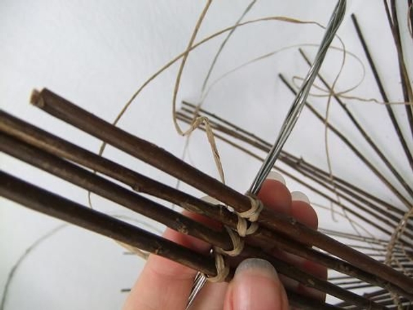 To make it easier to space out the twigs start by tying four twigs on opposite ends of the circle