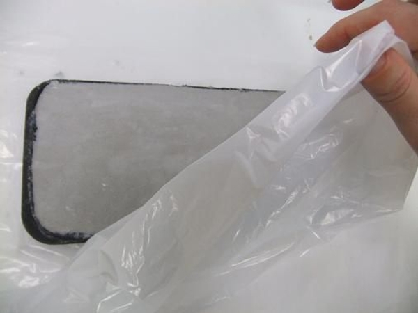 Cover the cement tray with plastic and set aside to let the water soak in. Cover the cement tray with plastic and set aside to let the water soak in.