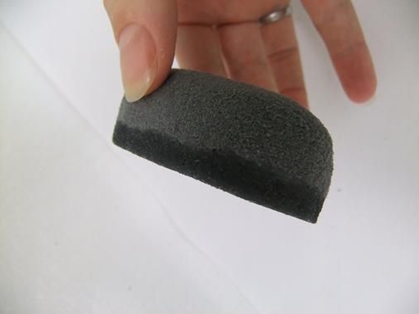 Dip the flat bottom of the pebble in the melted wax Dip the flat bottom of the pebble in the melted wax