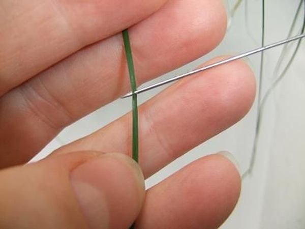 Make a small slit in the strand with a pin Make a small slit in the strand with a pin