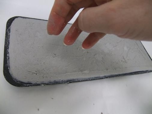 Place your hand in water and sprinkle to water on to the cement tray Place your hand in water and sprinkle to water on to the cement tray