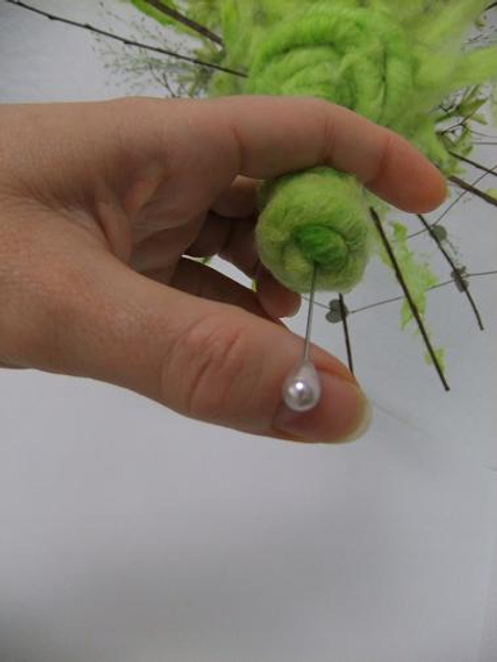 Push a corsage pin into the dried stem to secure the wool.jpg