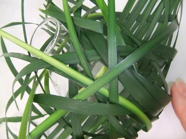 Fold each blade over the vase and weave it into the other side Fold each blade over the vase and weave it into the other side