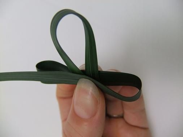 Loop the grass around the back and to the front Loop the grass around the back and to the front