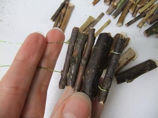 Thread twigs on wire. Thread twigs on wire.