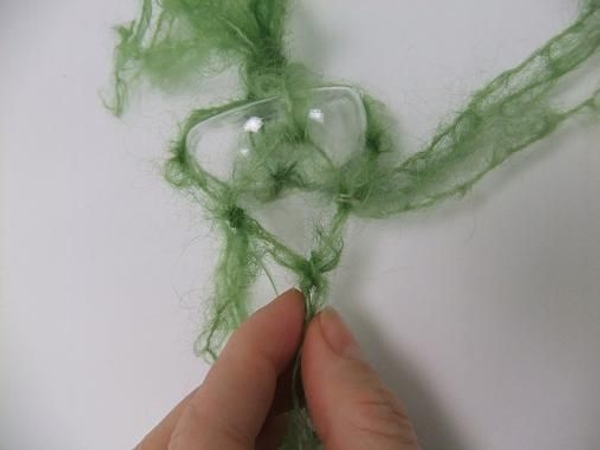 Divide the strands and knot again to fit tightly around the neck of the bud vase Divide the strands and knot again to fit tightly around the neck of the bud vase