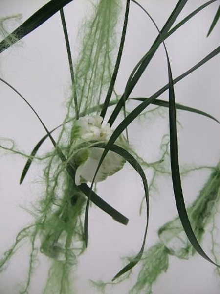Drape the wool strands over the flowers to soften the lines Drape the wool strands over the flowers to soften the lines