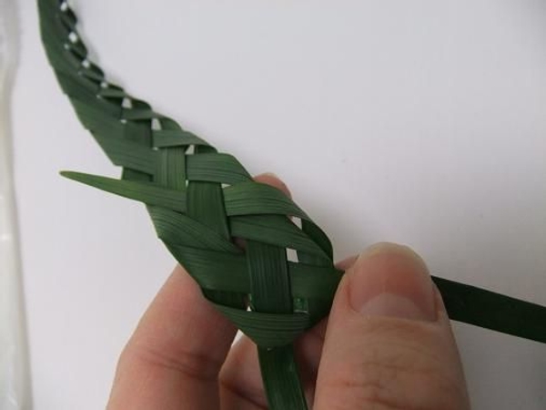 Fold the grass over and weave it back in Fold the grass over and weave it back in