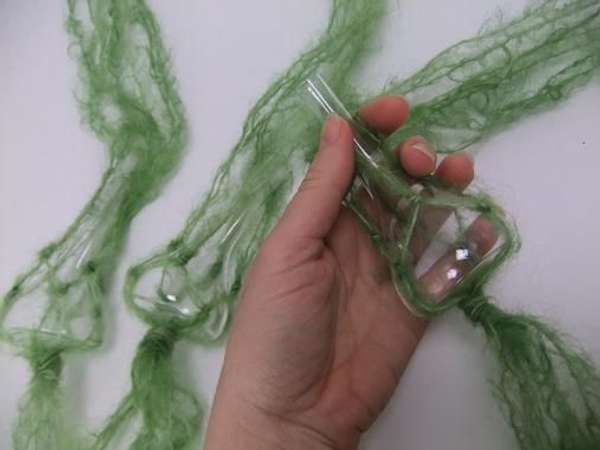 Fold the long dangling strands up and over the vase Fold the long dangling strands up and over the vase