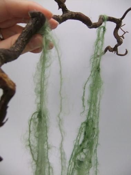 Hang the vase from the last two strands and let the ends dangle down the vase Hang the vase from the last two strands and let the ends dangle down the vase