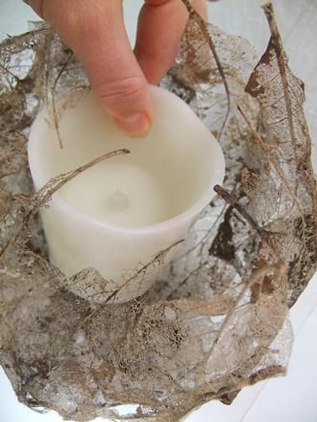 Place the flameless candle in the cavity. Place the flameless candle in the cavity.