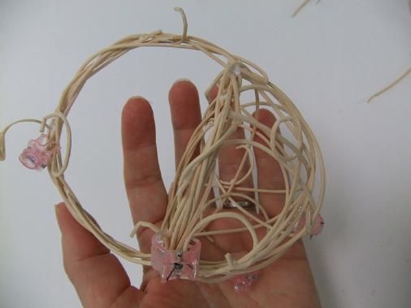 Curl a few rattan pieces and weave and glue it into the basket design Curl a few rattan pieces and weave and glue it into the basket design