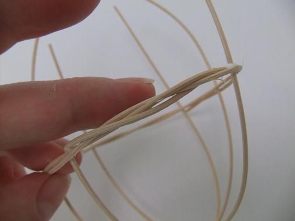 Fold the first rattan piece over and weave it into the wreath Fold the first rattan piece over and weave it into the wreath