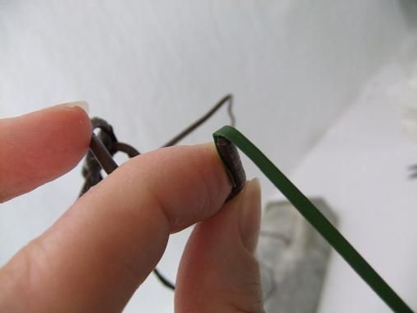 Fold the first strip over the wire end. Fold the first strip over the wire end.