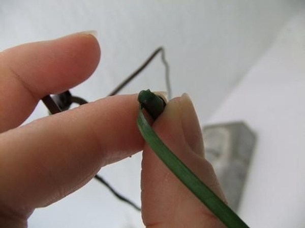 Fold the strip to the side and start to cover the wire Fold the strip to the side and start to cover the wire