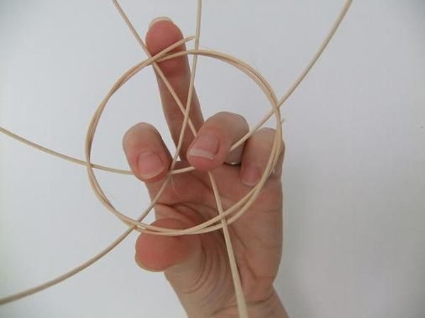 Gently pull the rattan pieces down from the wreath to create a basket shape. Gently pull the rattan pieces down from the wreath to create a basket shape.
