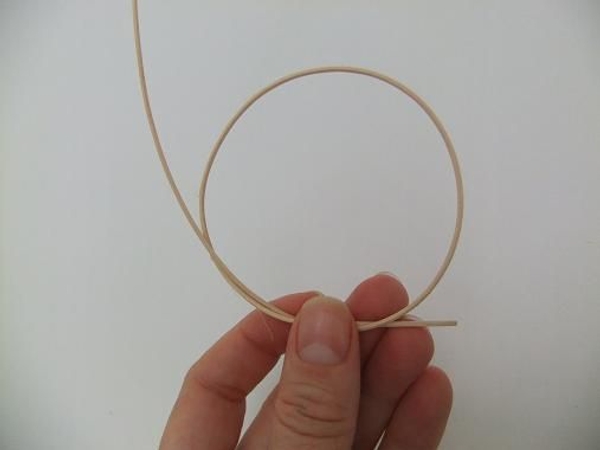 Loosely knot the thin rattan to create a loop Loosely knot the thin rattan to create a loop