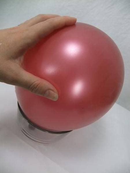Place an inflated balloon knot side down on a vase. Place an inflated balloon knot side down on a vase.