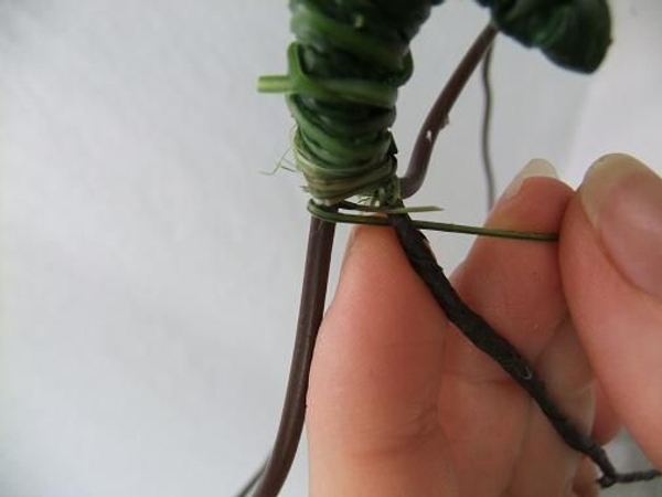 Weave the strand under the first wire and around the next wire and again under the last wire. Weave the strand under the first wire and around the next wire and again under the last wire.