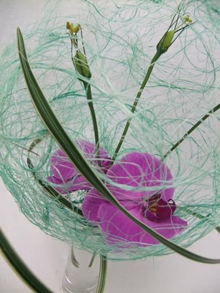 Wrap a few blades of grass to hug the design. Wrap a few blades of grass to hug the design.