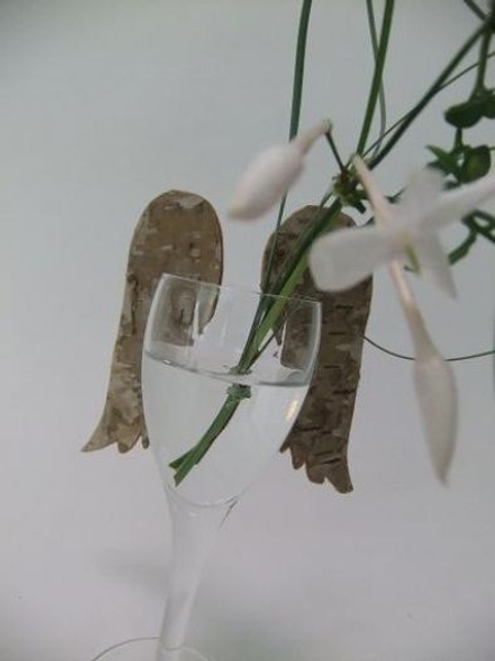 Birch bark wings hook on to the rim of a glass. Birch bark wings hook on to the rim of a glass.