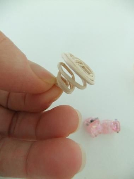 Gently pull the curl to spiral out Gently pull the curl to spiral out