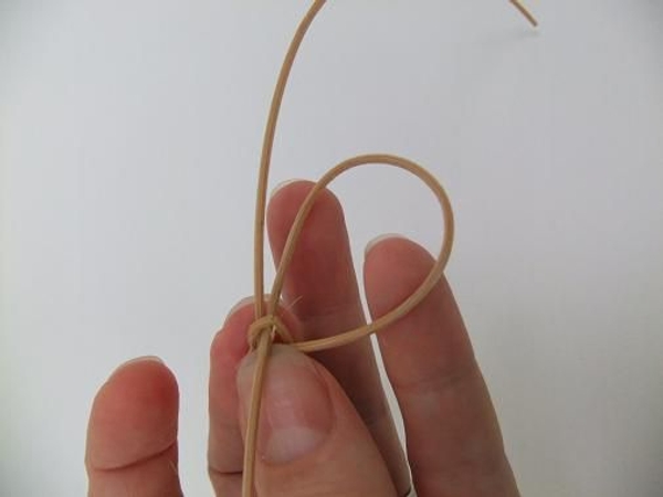 Thread one dangling leg of the rattan knot back through Thread one dangling leg of the rattan knot back through