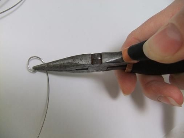 Curl the end of the wire with pliers. Curl the end of the wire with pliers.