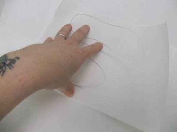 Fold the thin paper over the drawn slipper pattern Fold the thin paper over the drawn slipper pattern