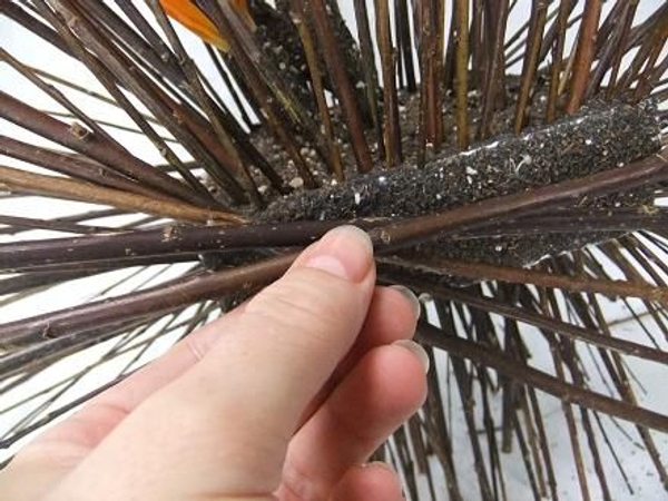 Pin a few twigs to hide most of the foam block Pin a few twigs to hide most of the foam block