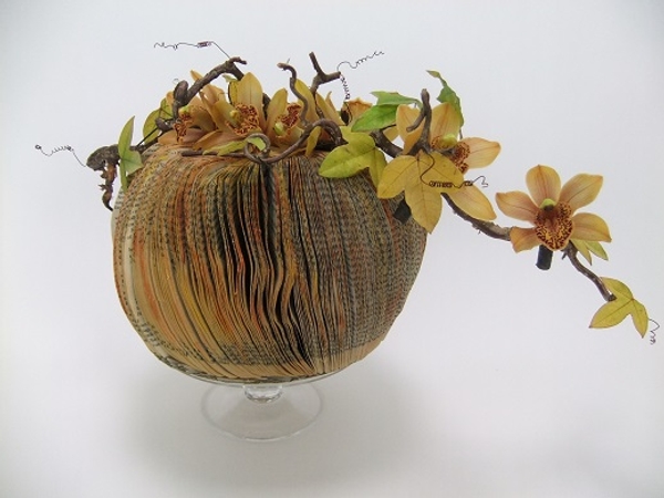 Cymbidium, hazel and passion fruit vines on a paperback book pumpkin Cymbidium, hazel and passion fruit vines on a paperback book pumpkin