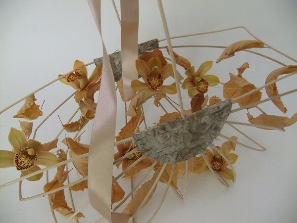 Open basket filled with fall leaves and flowers