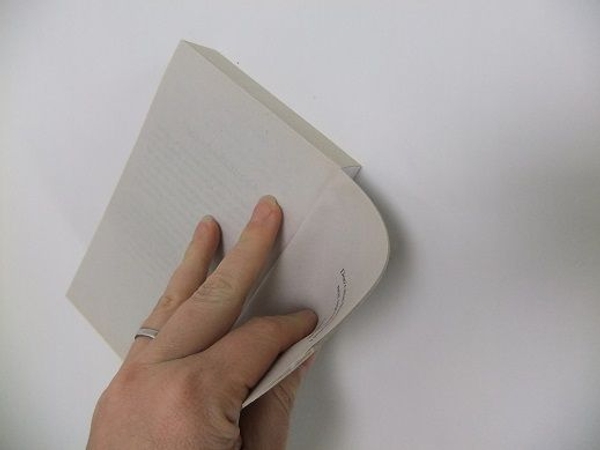 Start to break the spine of the book by bending the pages back Start to break the spine of the book by bending the pages back
