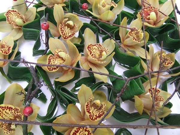 Fold a few leaves in a zig zag pattern to support the orchids