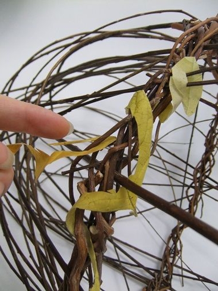 Hook the inside of the leaf spiral around a twig and start to wrap Hook the inside of the leaf spiral around a twig and start to wrap