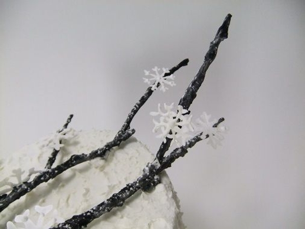 Marzipan twig and icing sugar snowflakes