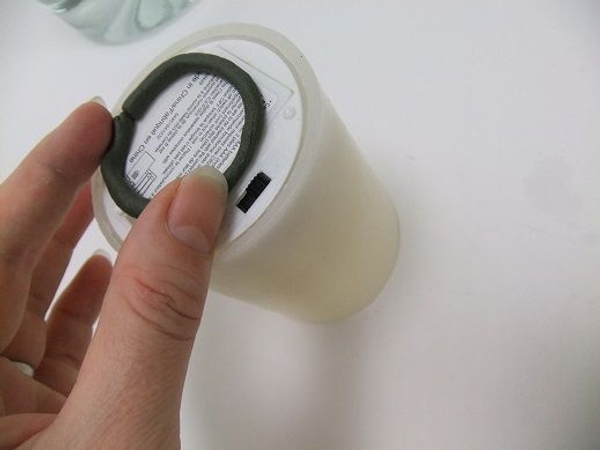 Place the putty at the bottom of the candle Place the putty at the bottom of the candle