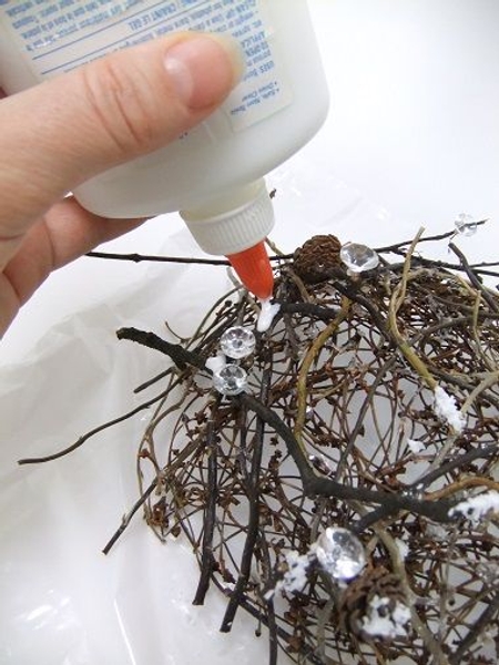 Pour out a few drops of wood glue on to the twigs Pour out a few drops of wood glue on to the twigs