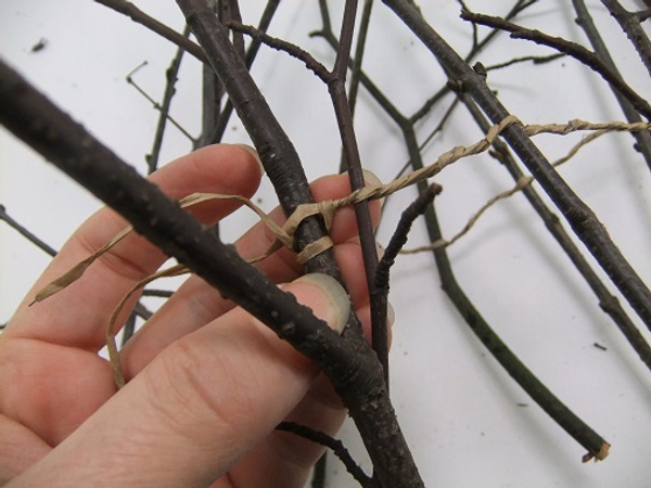 Fold the twig garland in half and twist the wire to secure