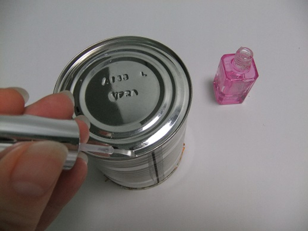 Paint the bottom rim of the can with a bit of clear nail varnish.