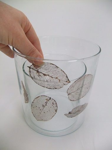 Place a few skeleton leaves in the dry outside vase Place a few skeleton leaves in the dry outside vase