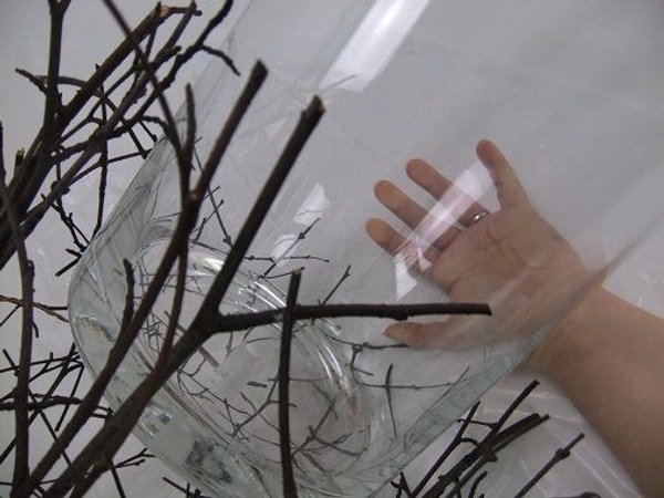 Slip a tall vase between the twigs and set it upright Slip a tall vase between the twigs and set it upright