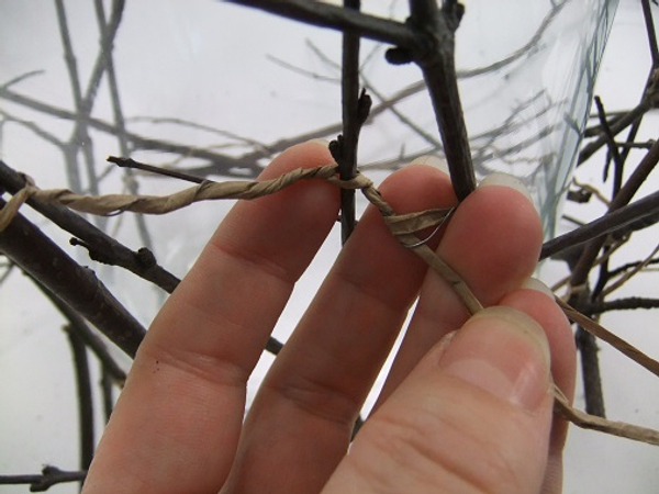 Split the wire open and twist it to secure the next twig