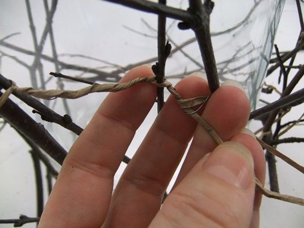 Split the wire open and twist it to secure the next twig Split the wire open and twist it to secure the next twig